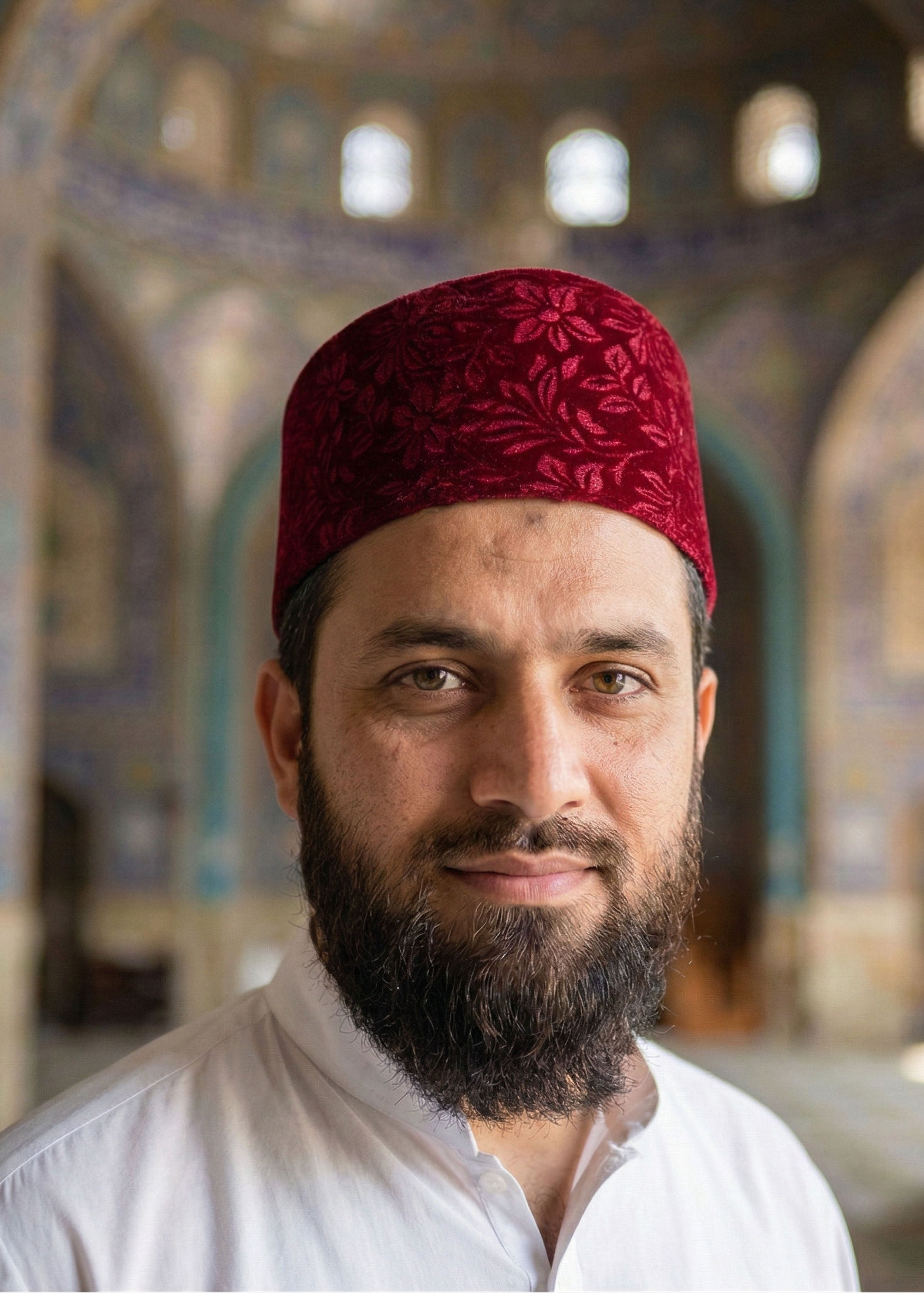 Man wearing a red fez hat in a decorated interior setting