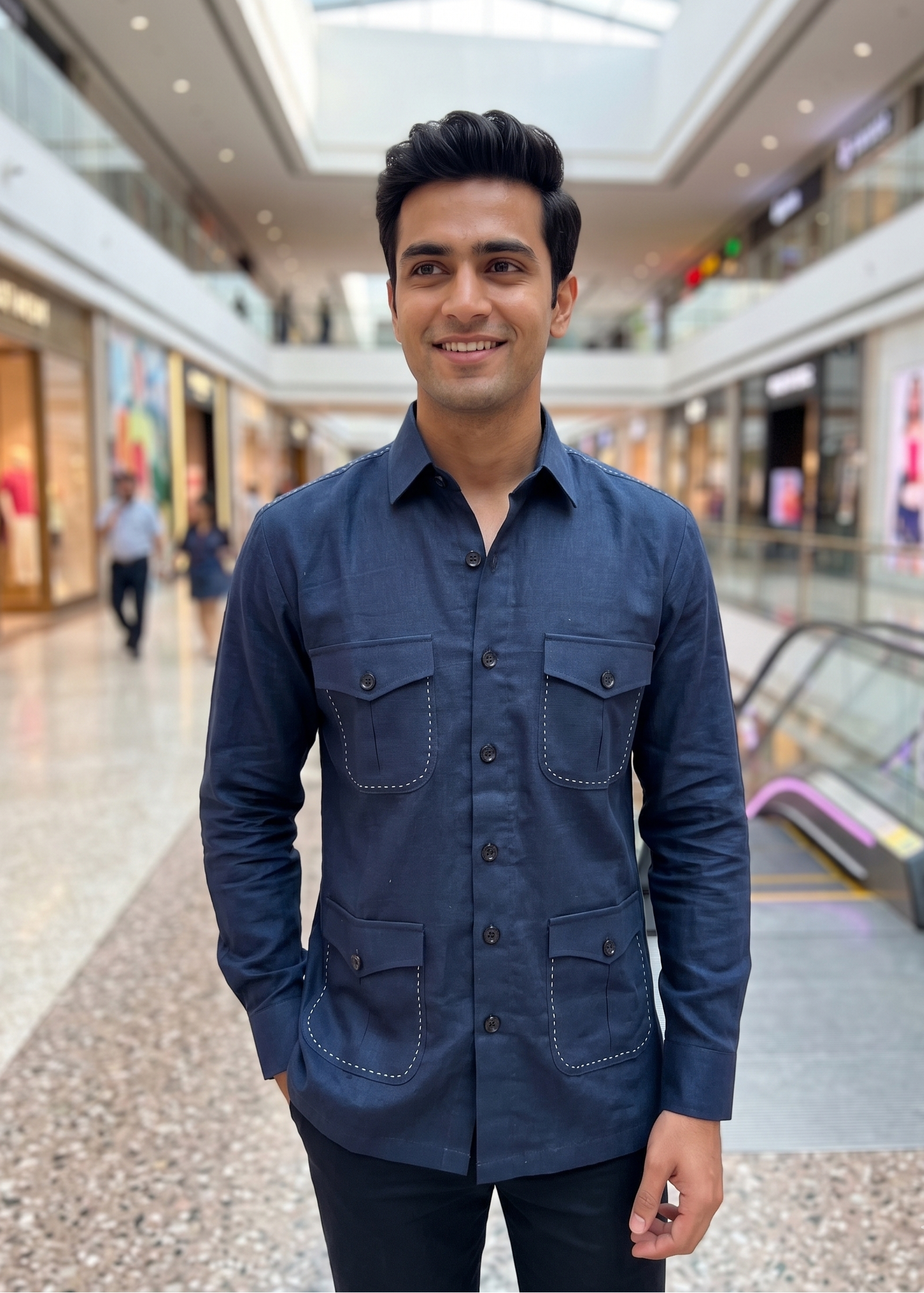 Man in a blue shirt standing in a shopping mall